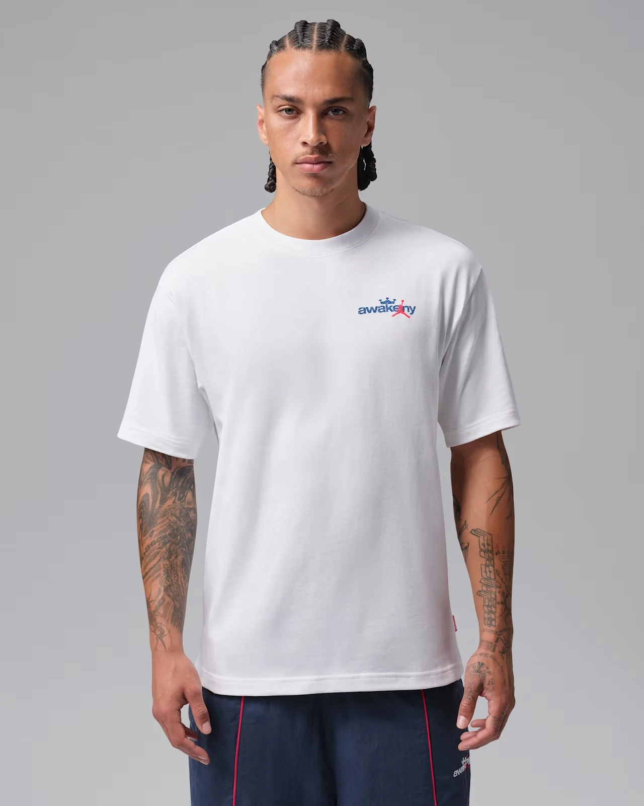 Front view of Jordan x Awake NY white T-shirt with Game Royal and Infrared 23 branding.