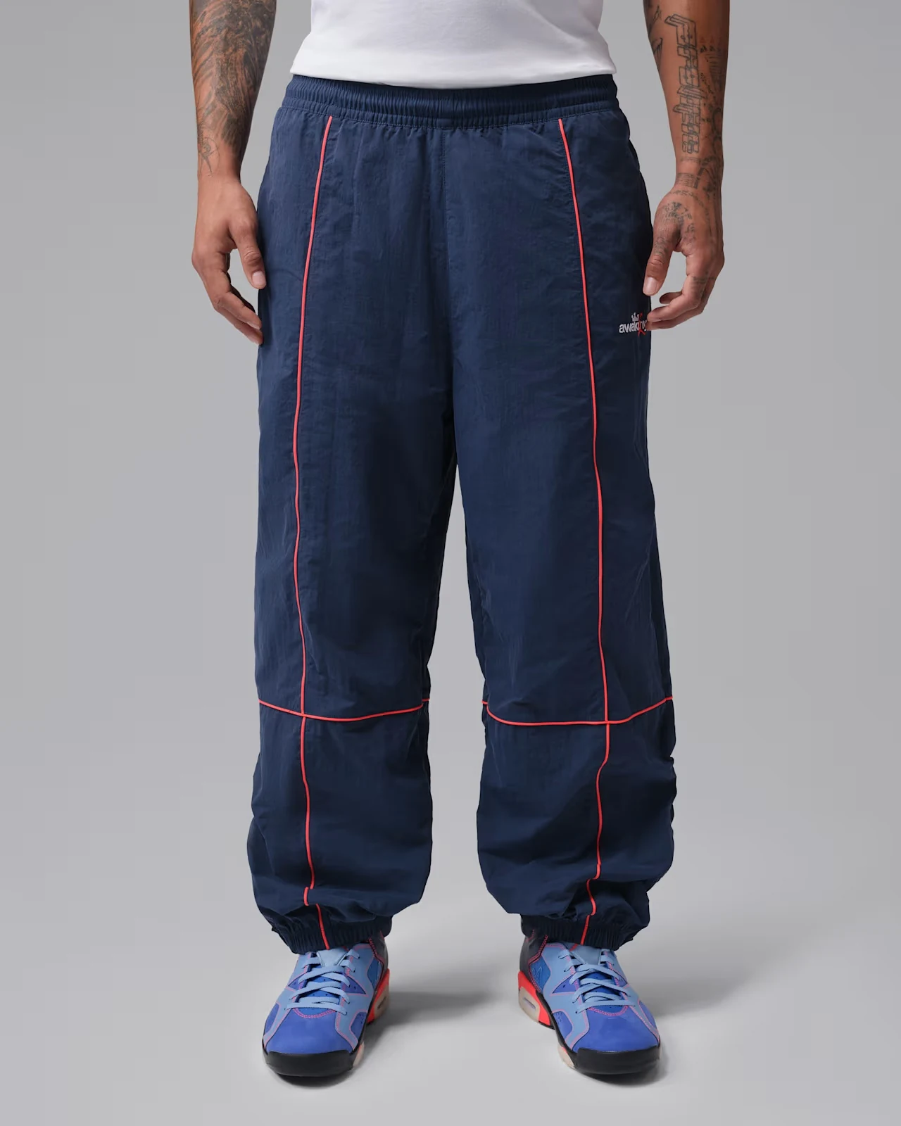 Jordan x Awake NY track pants in Midnight Navy with Infrared 23 piping.