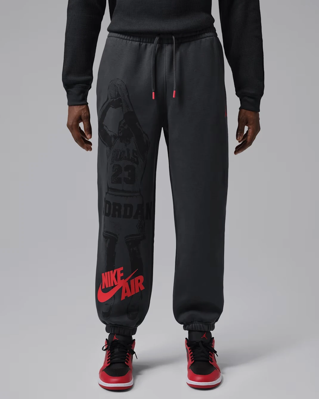Front view of the Jordan Brooklyn Fleece Men's Cuffed Pants in Off Noir with University Red graphics.