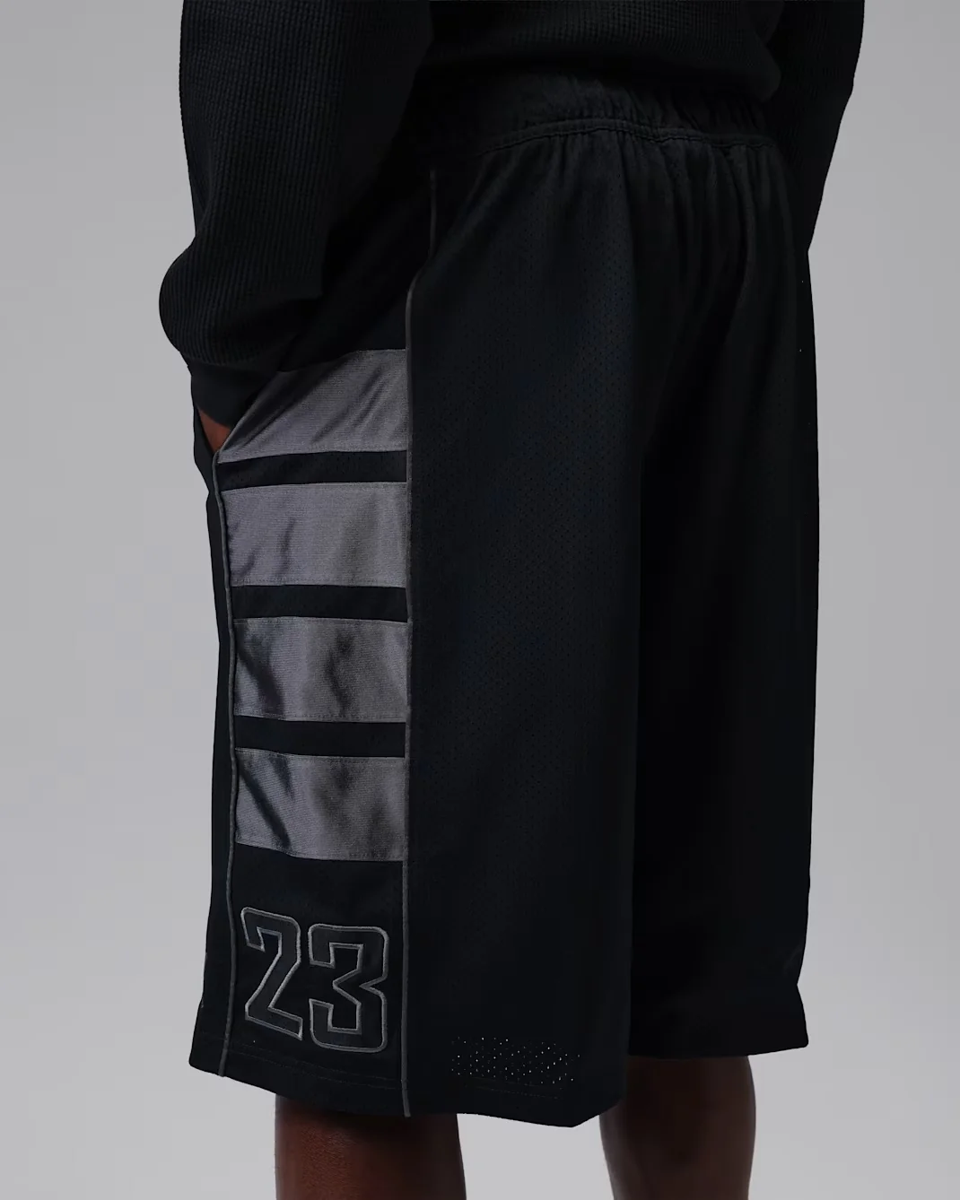 Side view of Jordan Brooklyn Mesh Cat Scratch Shorts in Black and Dark Smoke Grey