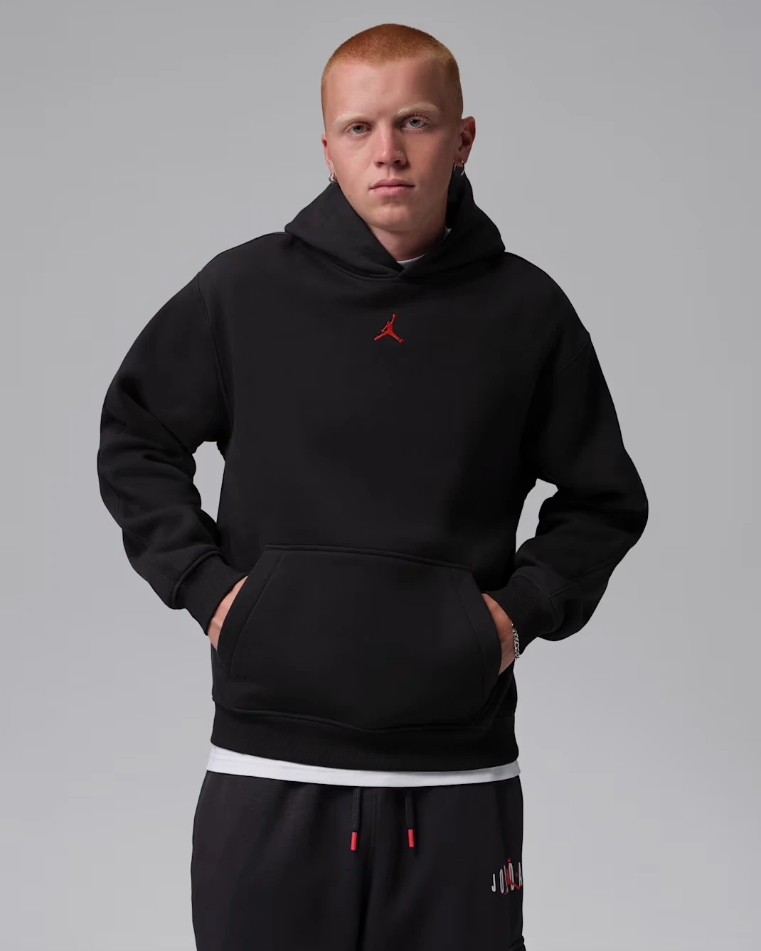 Front view of the Jordan Brooklyn Men's Pullover Hoodie in Off Noir with University Red Jumpman logo.
