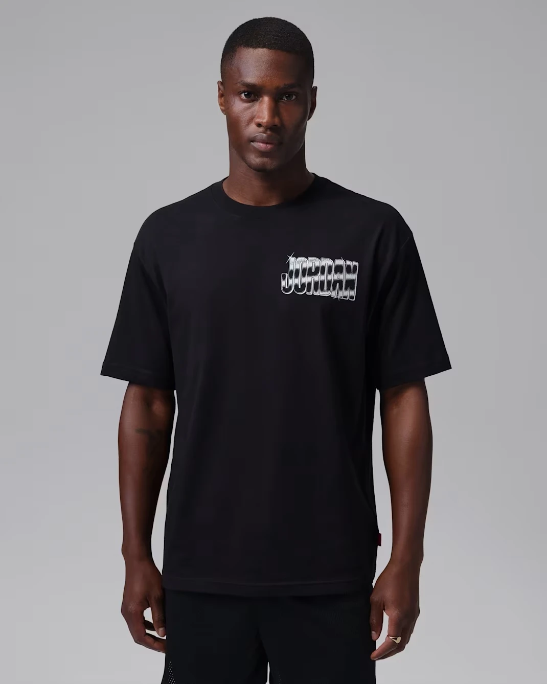 Front view of the black Jordan Brooklyn men's T-shirt with white Jordan graphic