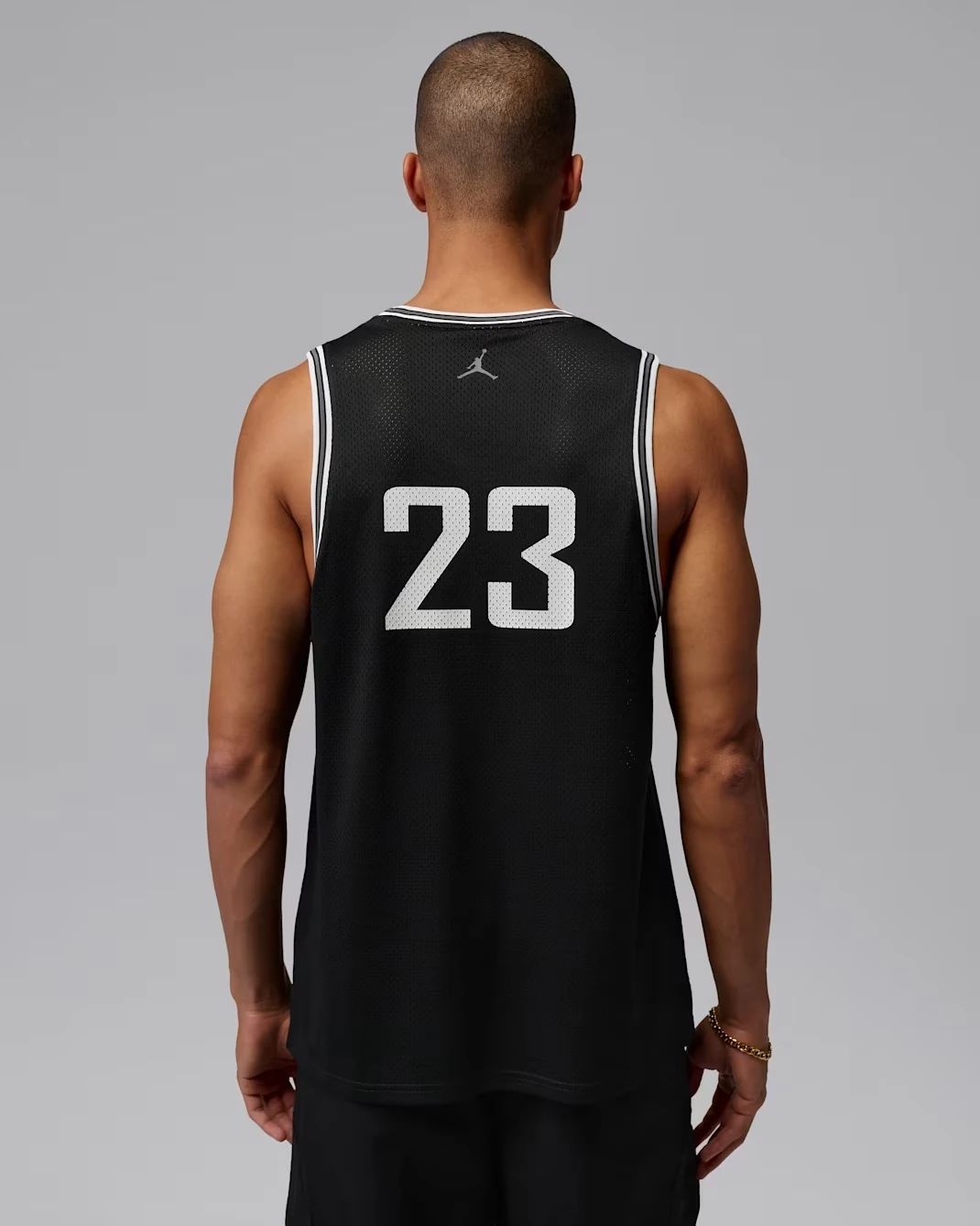Back view of the black Jordan Brooklyn mesh jersey with white number 23