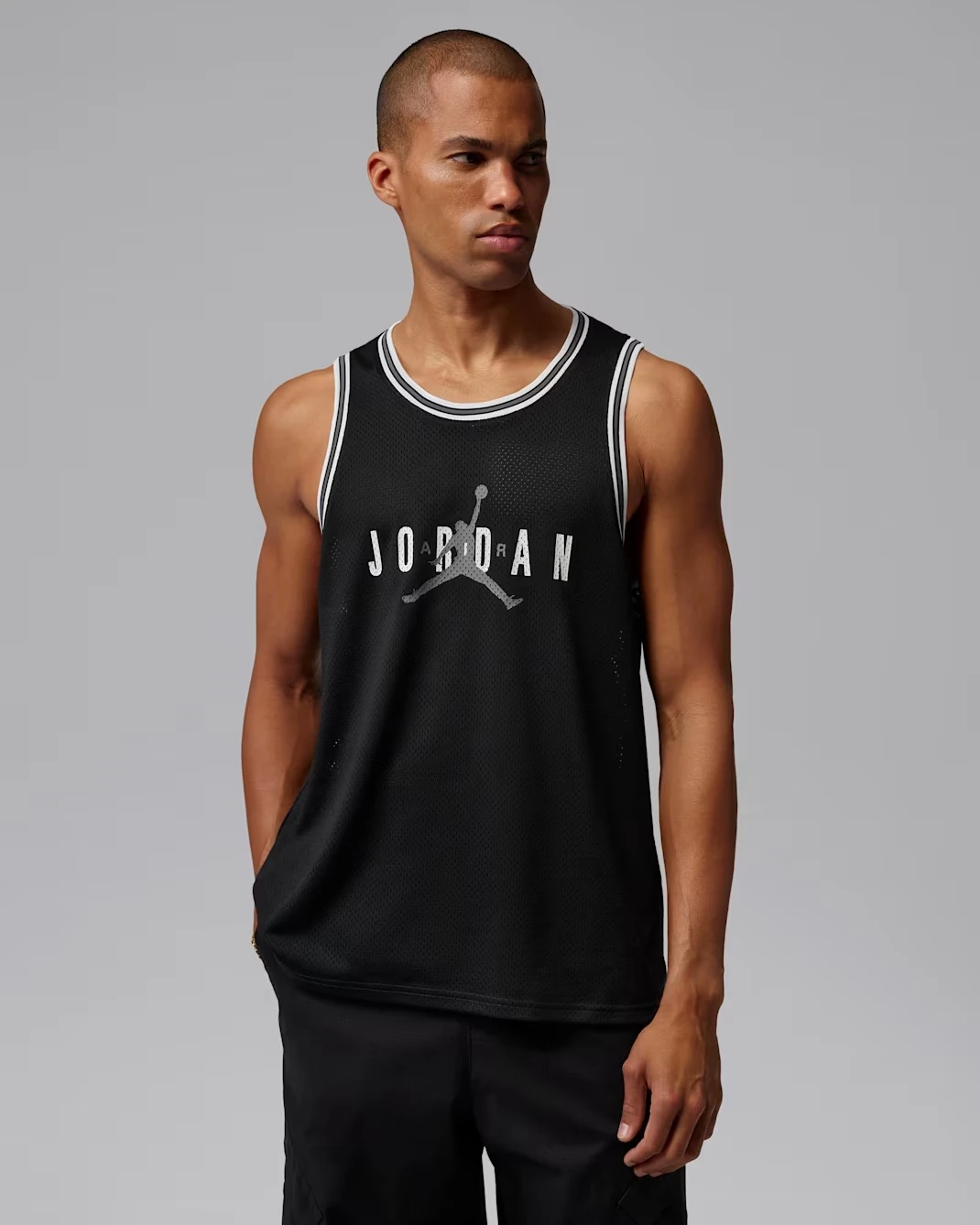 Front view of the black Jordan Brooklyn mesh jersey with white trim
