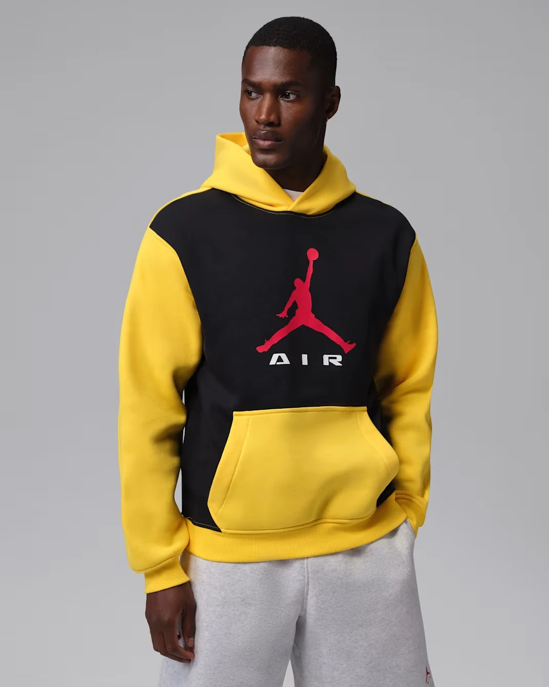 Jordan Brooklyn black and Tour Yellow pullover hoodie with red Jumpman logo.