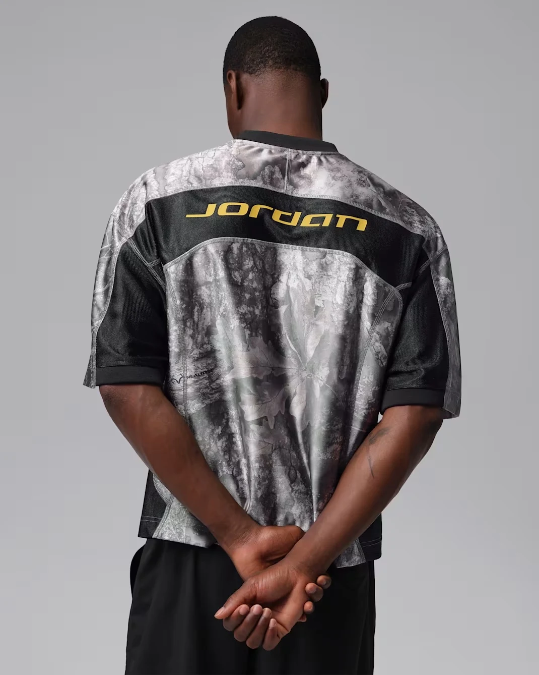 Back view of Jordan Brooklyn Realtree grey and black jersey top with yellow Jordan branding
