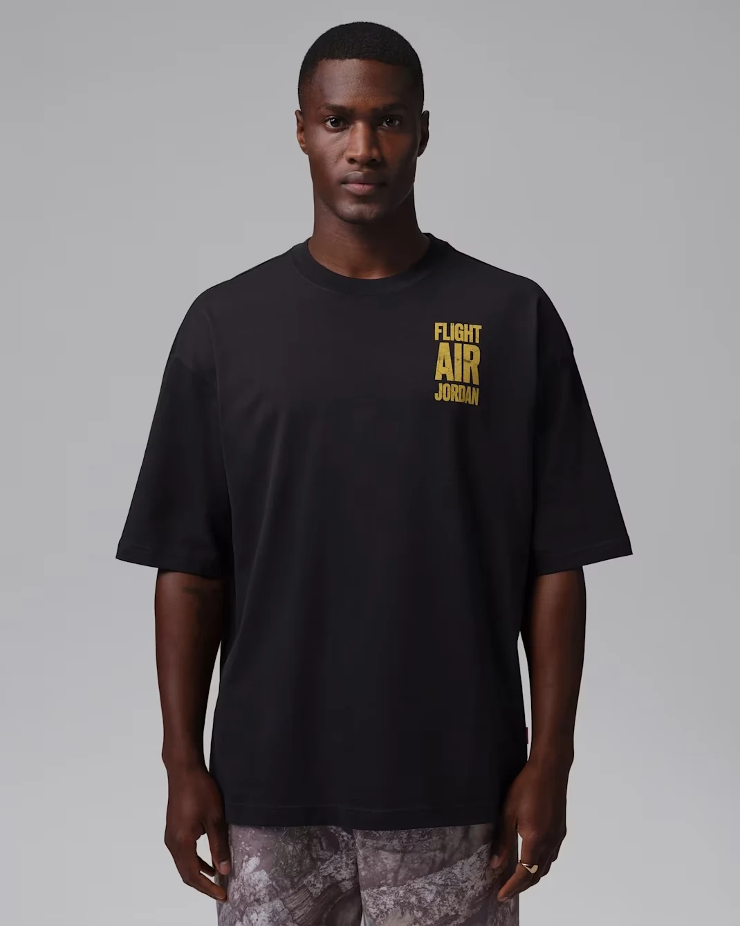 Front of black Jordan Flight T-shirt with Tour Yellow Flight Air Jordan chest graphic.