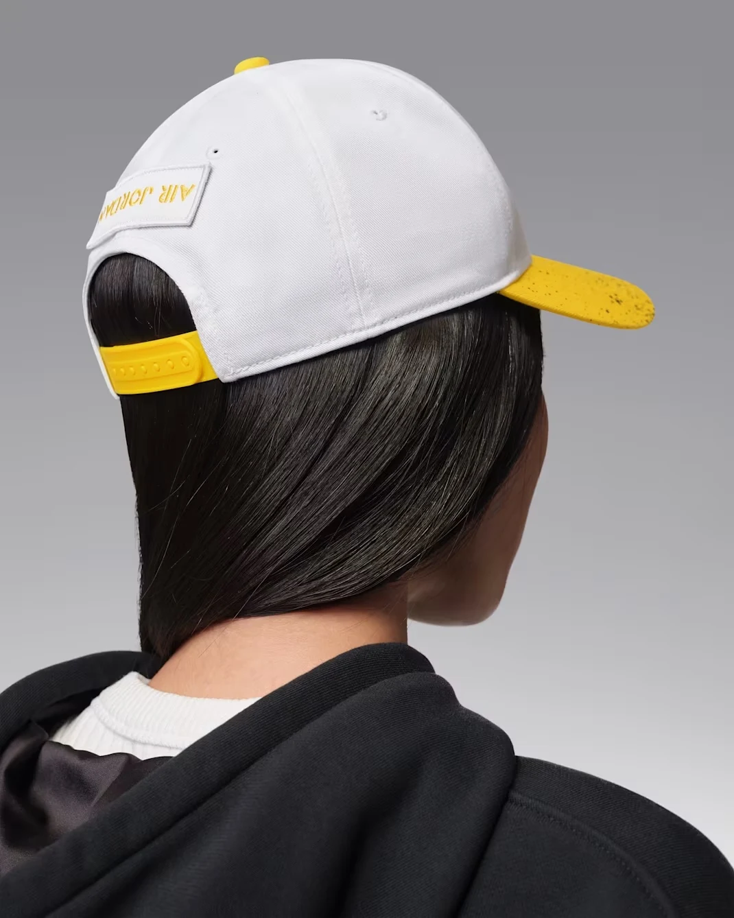 Back view of white and Tour Yellow Jordan Rise adjustable cap with yellow closure.