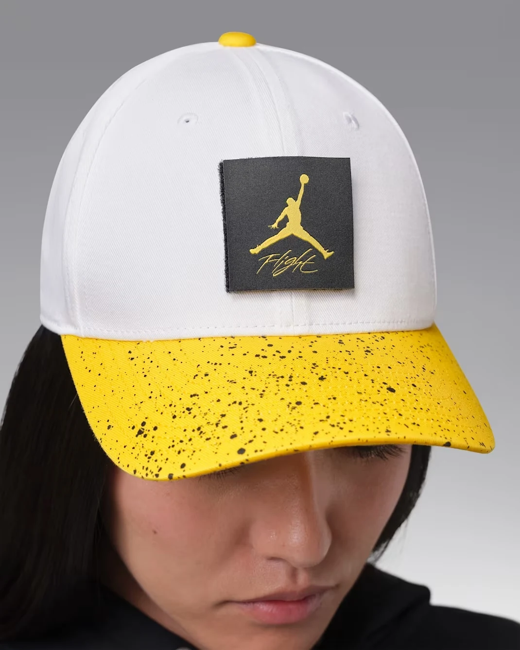 White and Tour Yellow Jordan Rise adjustable cap worn on model.