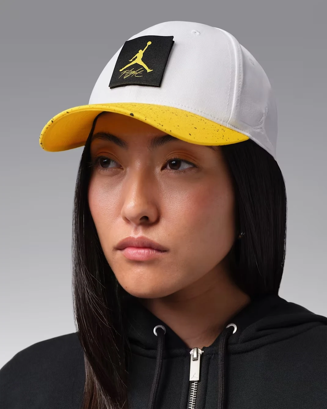 Front view of white Jordan Rise cap with Tour Yellow speckled brim and Jumpman Flight patch.