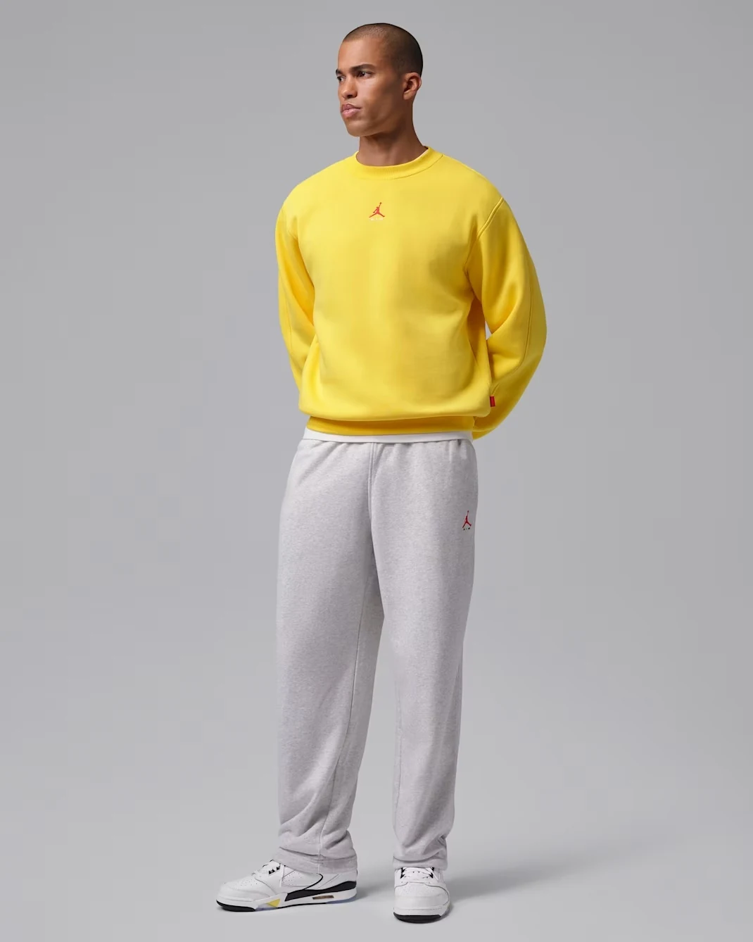 Jordan Sixty Plus Low Tour Yellow worn with a yellow Jordan sweatshirt and grey sweatpants.