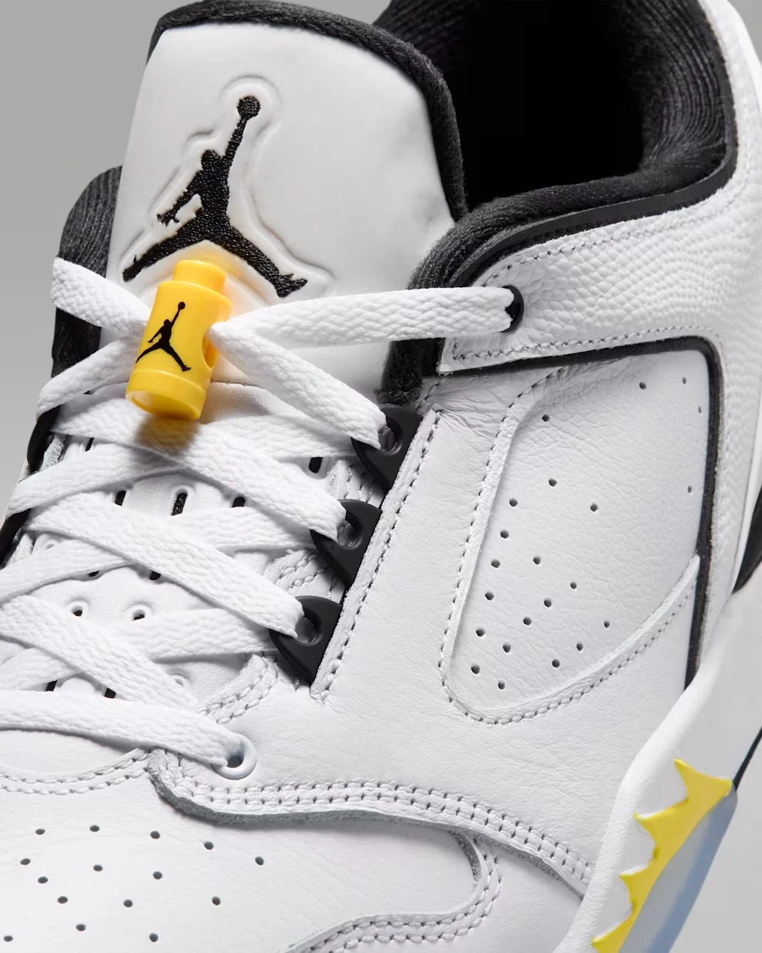 Close-up of the Jordan Sixty Plus Low Tour Yellow tongue, laces and yellow Jumpman lace lock.