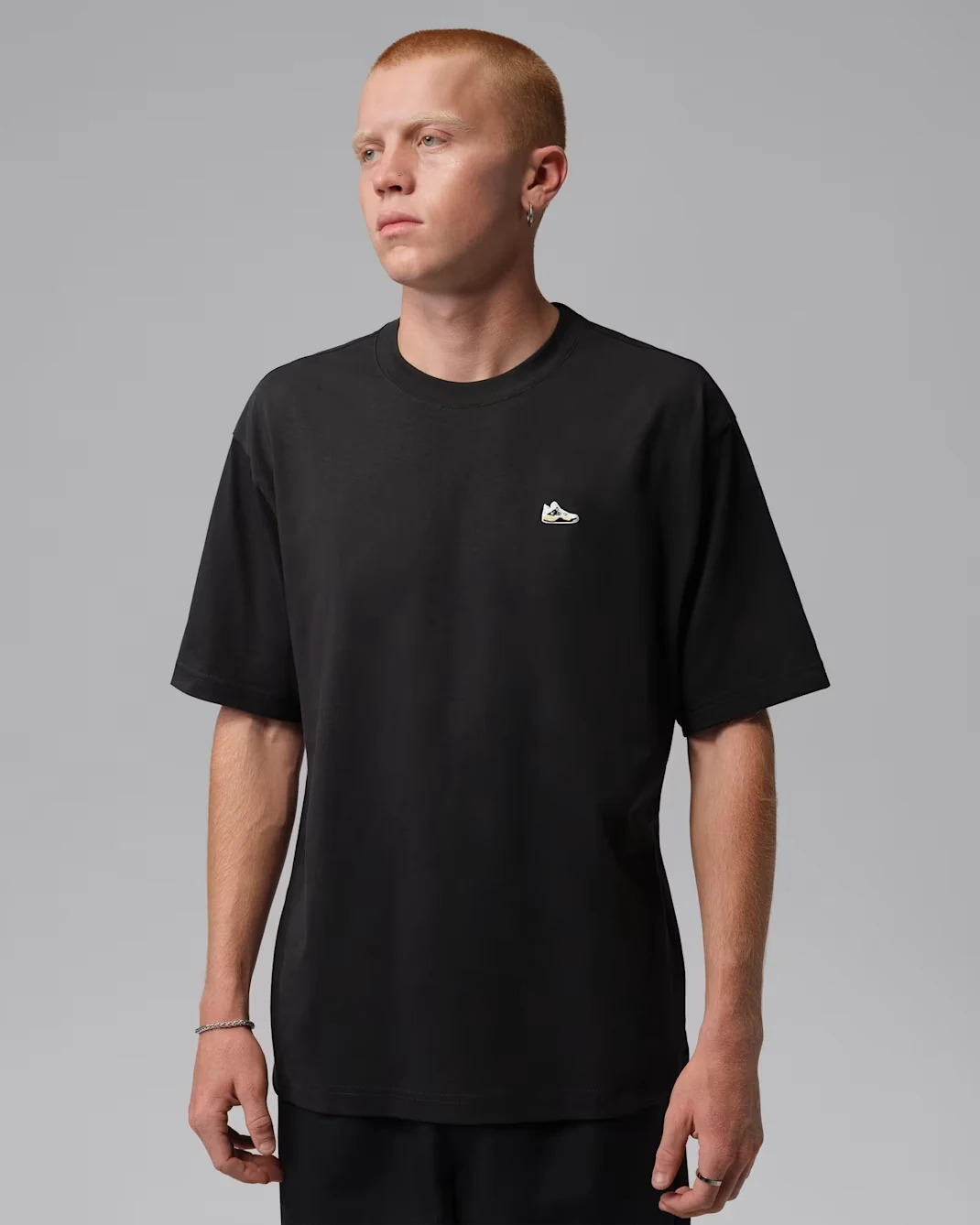 Black Jordan Sneaker Patch T-shirt with white, black and Tour Yellow sneaker graphic.
