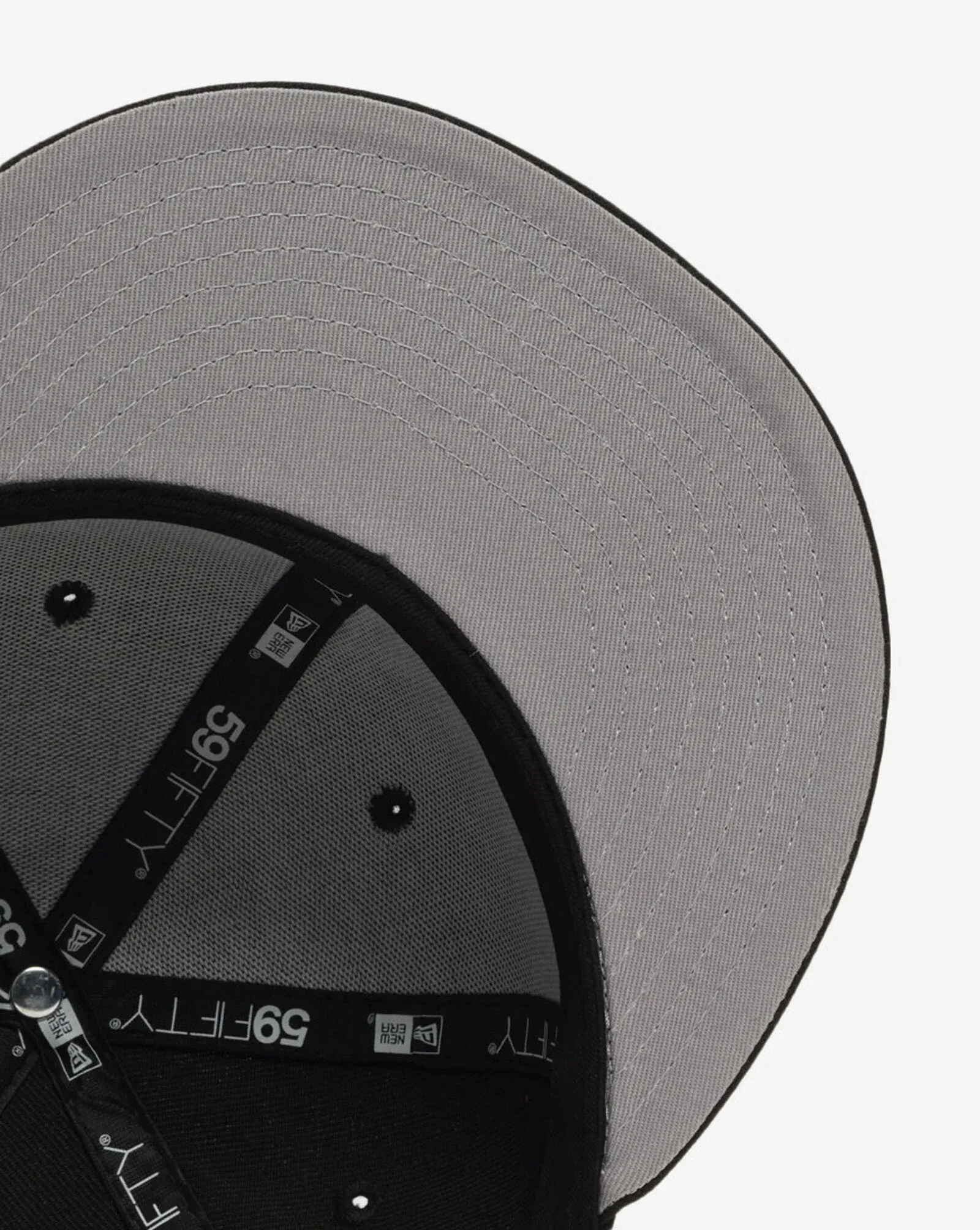 Grey underbrim and interior of the New Era Yankees Black/Graphite 59FIFTY fitted hat.