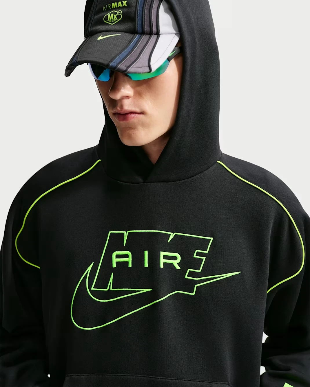 Full front view of the Nike Air Fleece Pullover Hoodie in Black with Neon Yellow Air graphics.