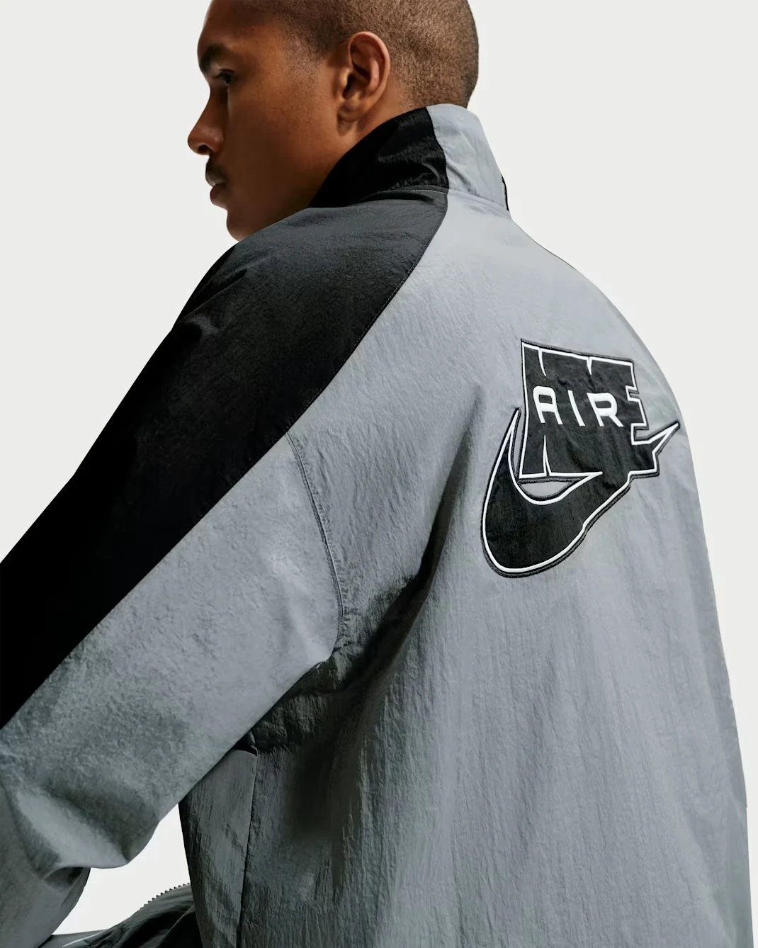 Nike Air woven track jacket in Smoke Grey and black back detail