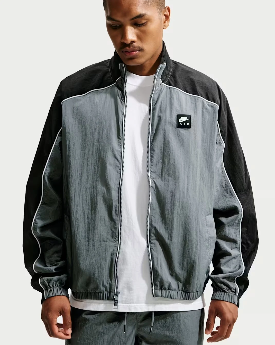 Nike Air woven track jacket in Smoke Grey and black front view
