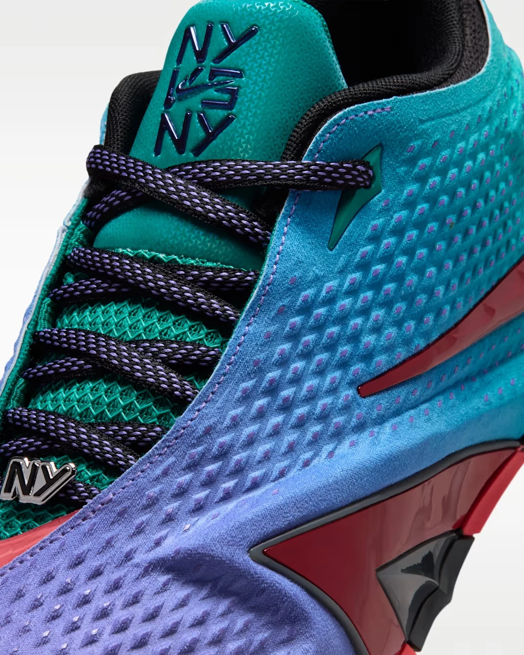 Close-up of the Nike Ja 4 NY vs. NY with NY tongue branding, Rio Teal upper and Persian Violet details.