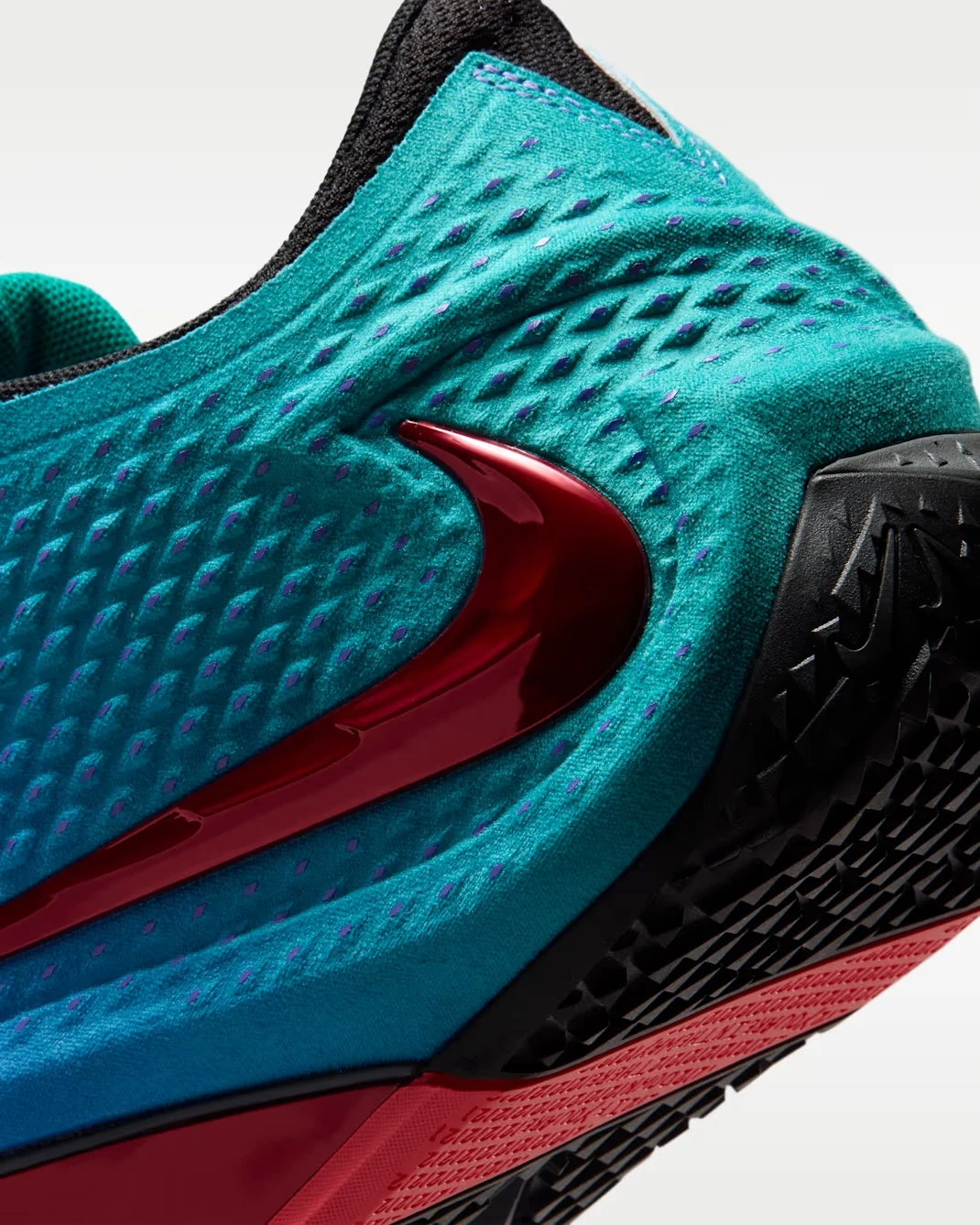 Close-up of the Nike Ja 4 NY vs. NY Rio Teal upper with Fruit Punch Nike Swoosh and purple details.