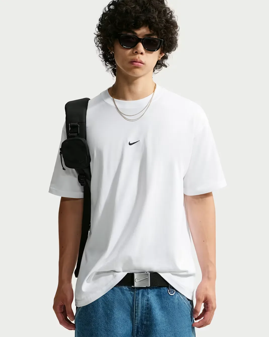 Nike Sportswear Men's Loose T-Shirt in black with a white Swoosh logo.
