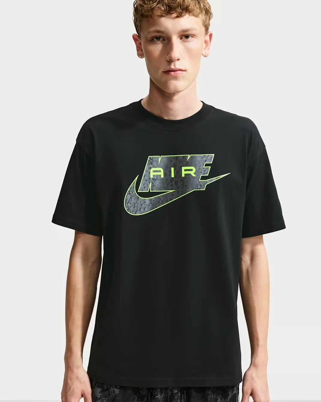 Front view of the Nike Sportswear T-Shirt in Black with Neon Yellow Air graphic.
