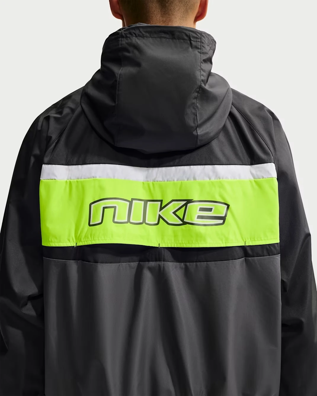 Back view of the Nike Windrunner Lined Jacket in Black, Anthracite and Neon Yellow.