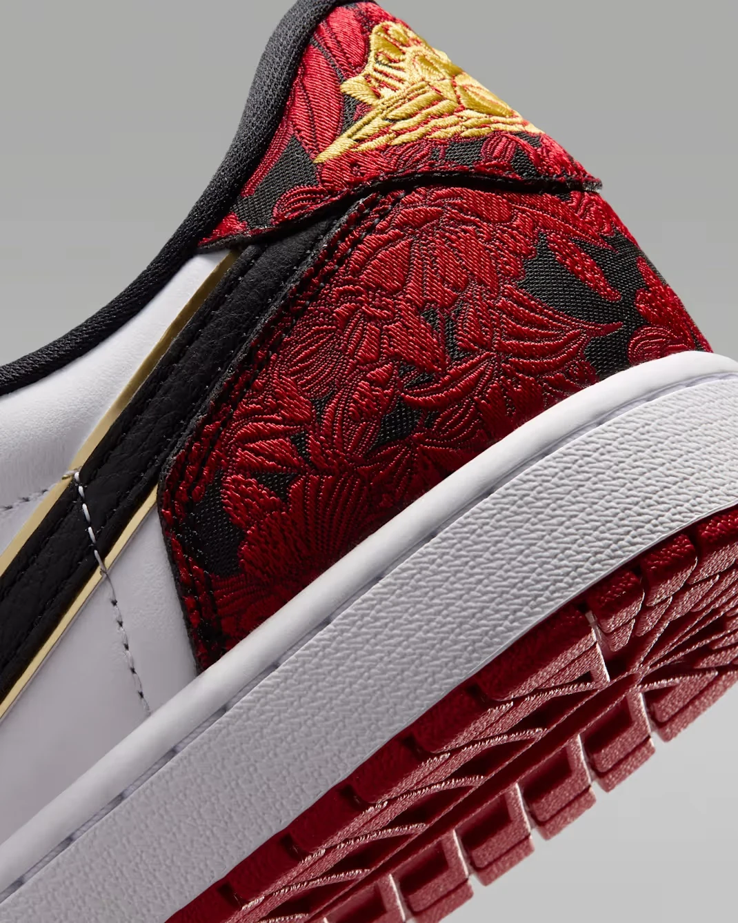 Red and black floral heel detail with gold Wings logo on the Air Jordan 1 Low OG Welcome to the Garden.