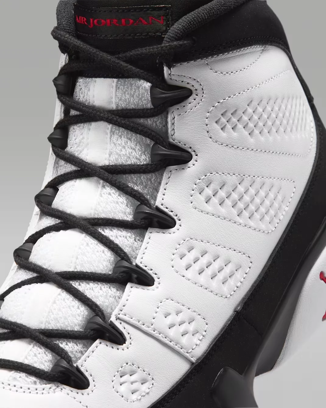 Close-up of the Air Jordan 9 Space Jam white upper, black laces and Air Jordan tongue branding.