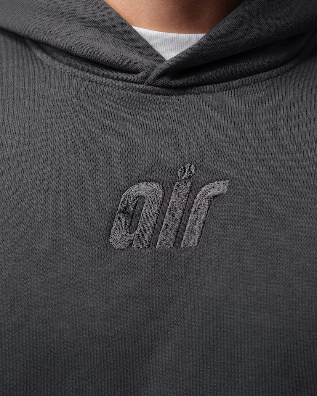 Tonal Air logo on the front of the Anthracite Jordan Brooklyn Fleece 23-Love hoodie.