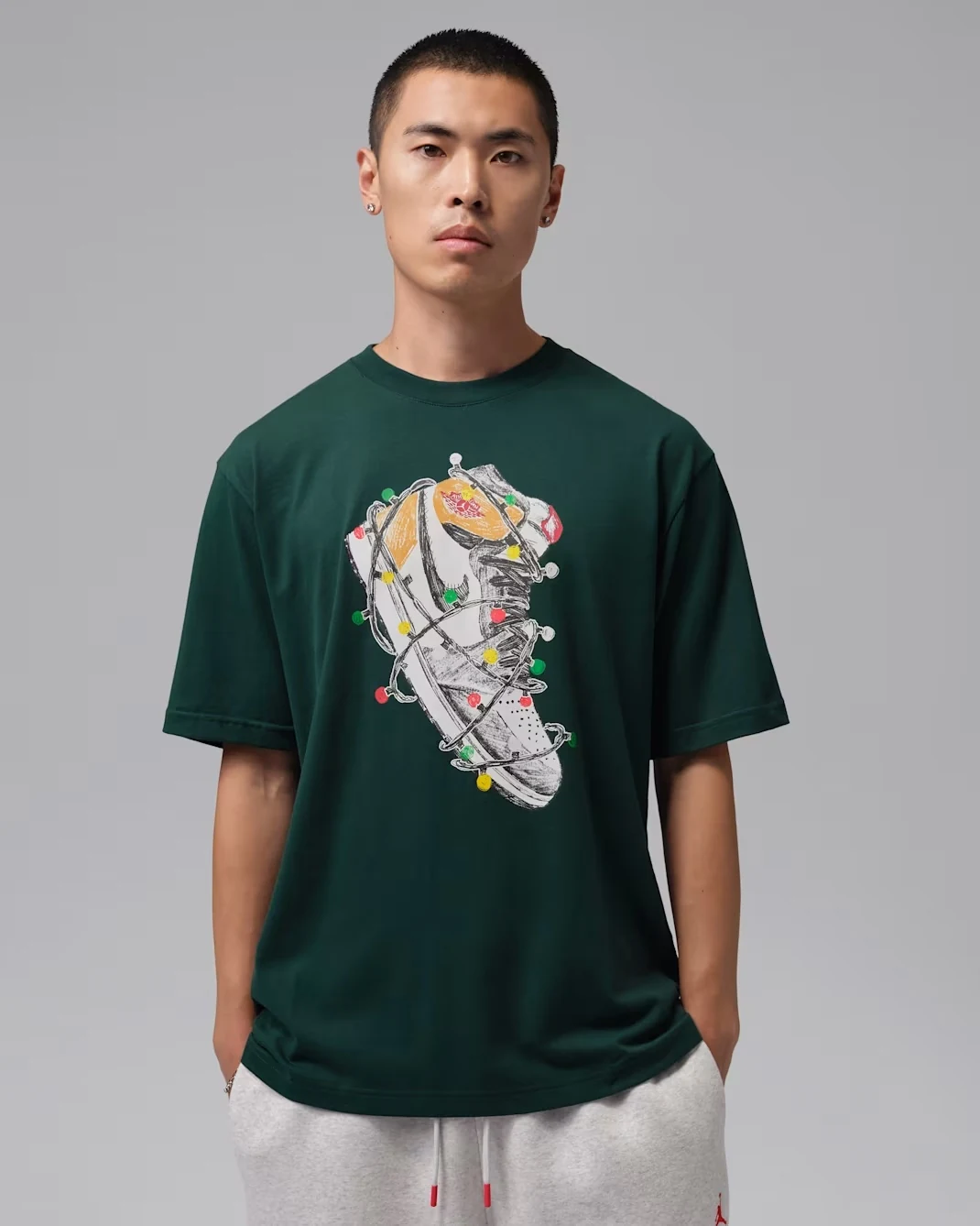 Jordan Brooklyn men's T-shirt in Midnight Spruce featuring a sneaker graphic with colorful holiday lights.