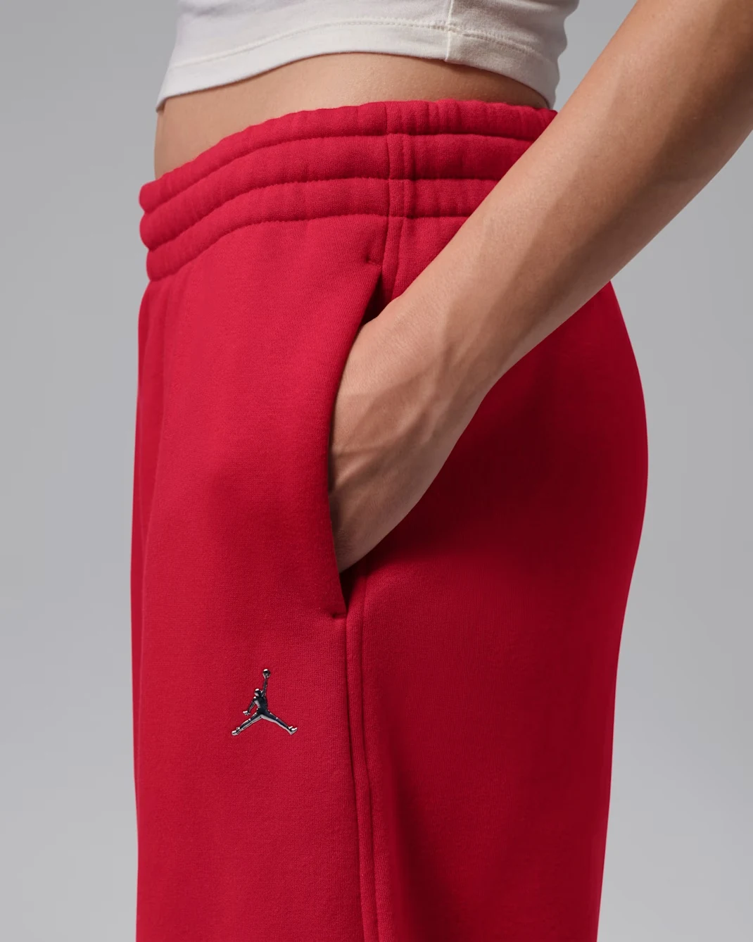 Close-up of Jordan Brooklyn women’s wide-leg pants in Gym Red with Metallic Silver Jumpman