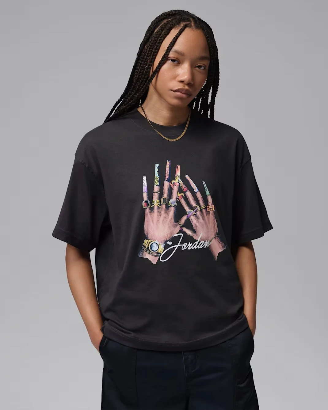 Model wearing the Off Noir Jordan Women’s Graphic Girlfriend T-Shirt with multicolor nail-inspired artwork.