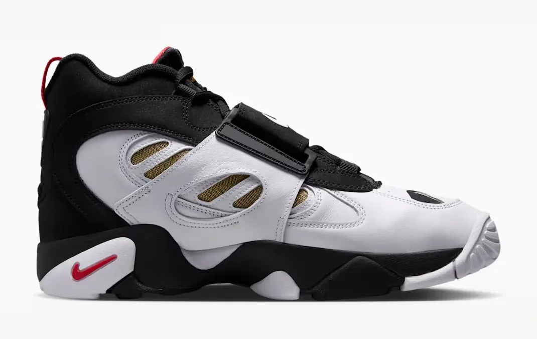 Side view of the Nike Air Diamond Turf 2 in Black, Fire Red, Metallic Gold and White with its midfoot strap.