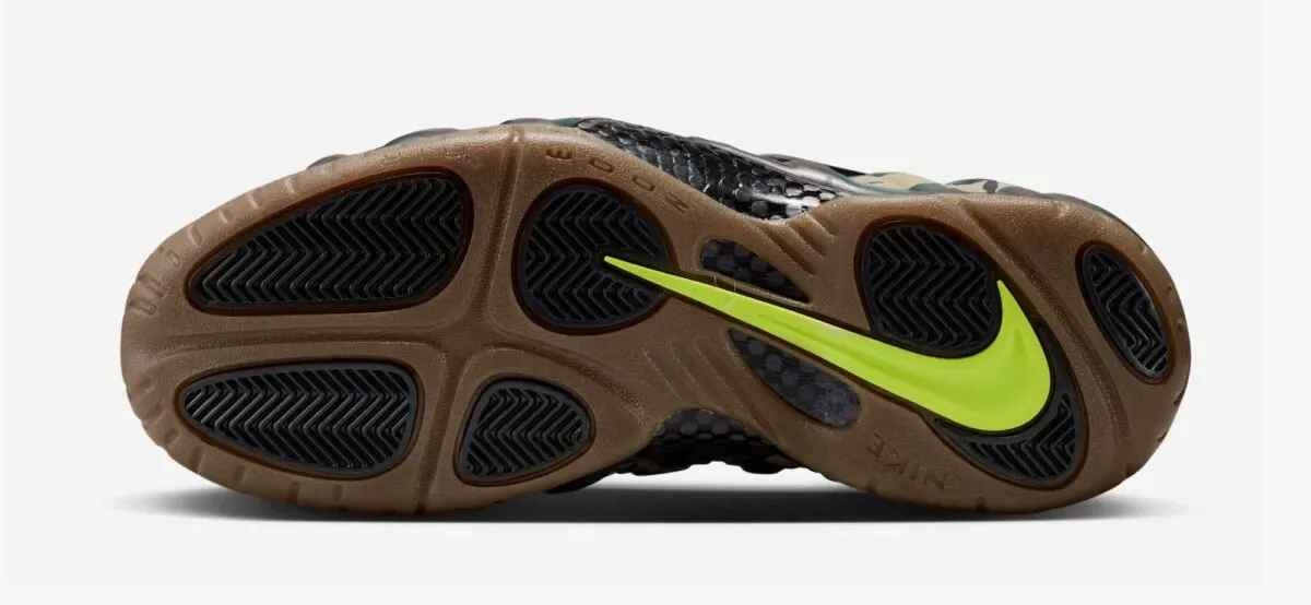 Gum Dark Brown outsole of the Nike Air Foamposite Pro Green Camo with black traction pods and Voltage Green Swoosh.