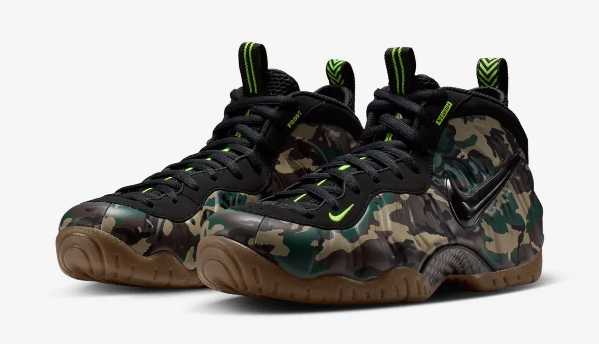 Pair of Nike Air Foamposite Pro Green Camo sneakers with black, green and brown camouflage and gum soles.