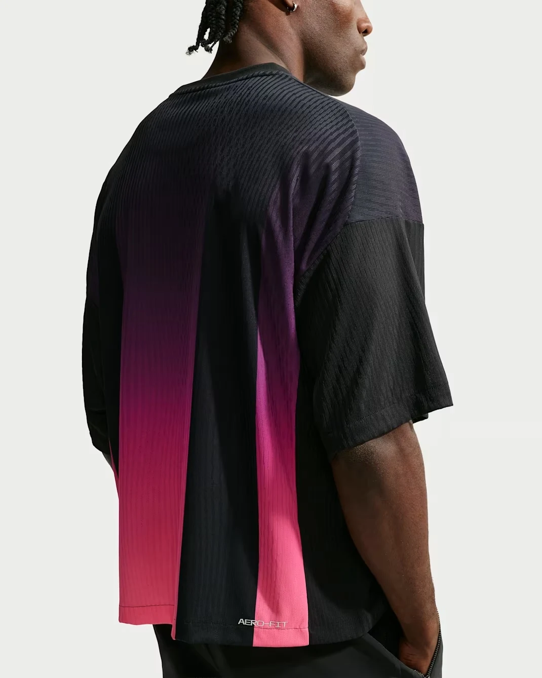 Back view of the Nike Kobe basketball jersey in black and fuchsia