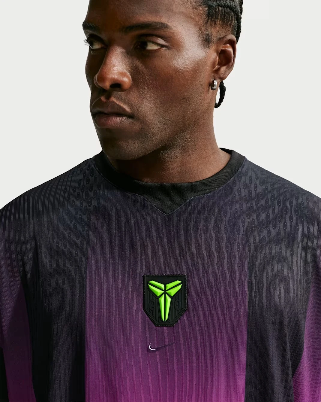 Close-up of Nike Kobe basketball jersey with lime Kobe logo and fuchsia gradient
