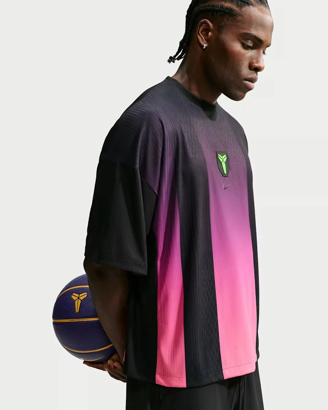 Side view of the Nike Kobe basketball jersey in black, fuchsia and lime green