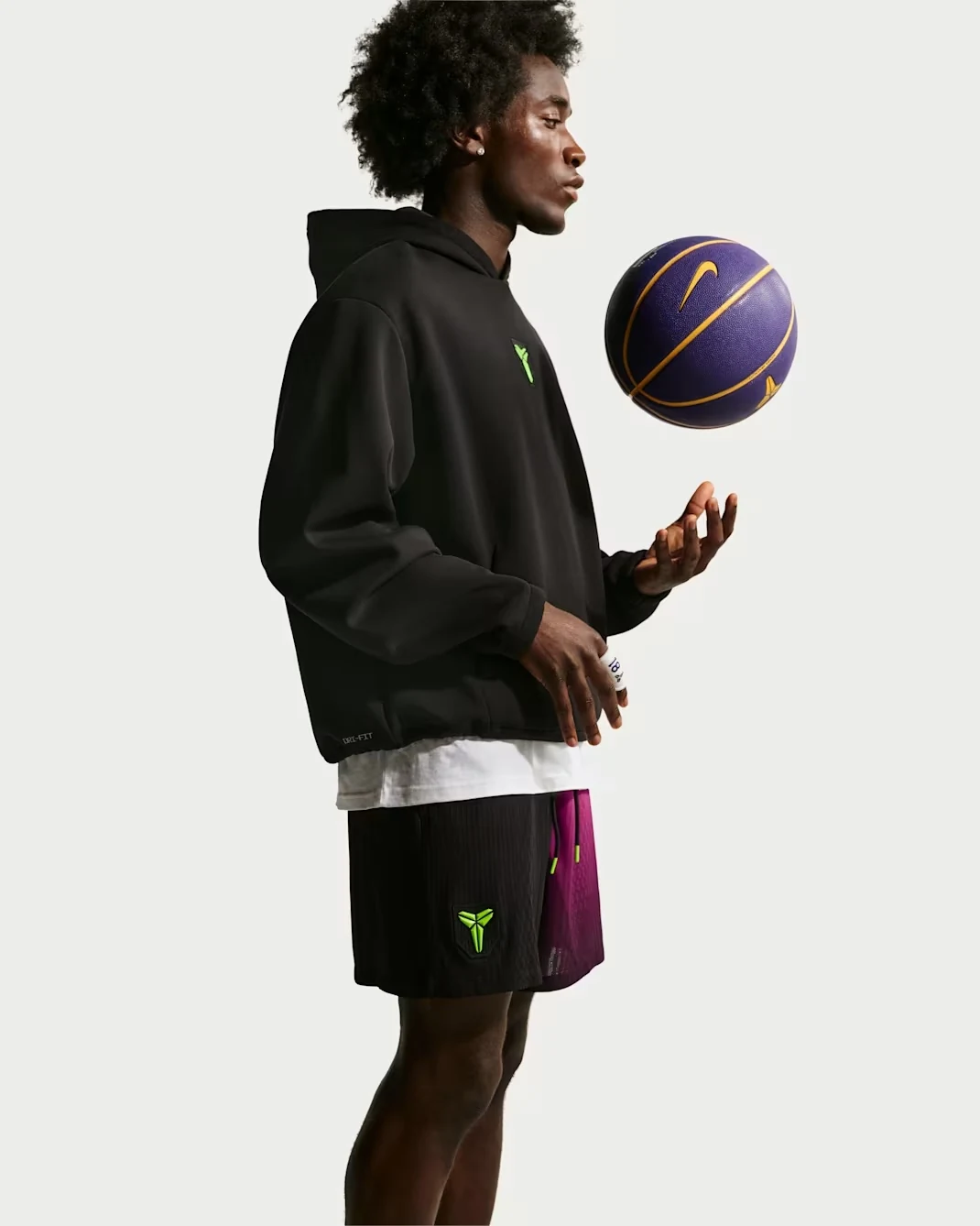 Side view of Nike Kobe black and fuchsia basketball shorts with matching black hoodie