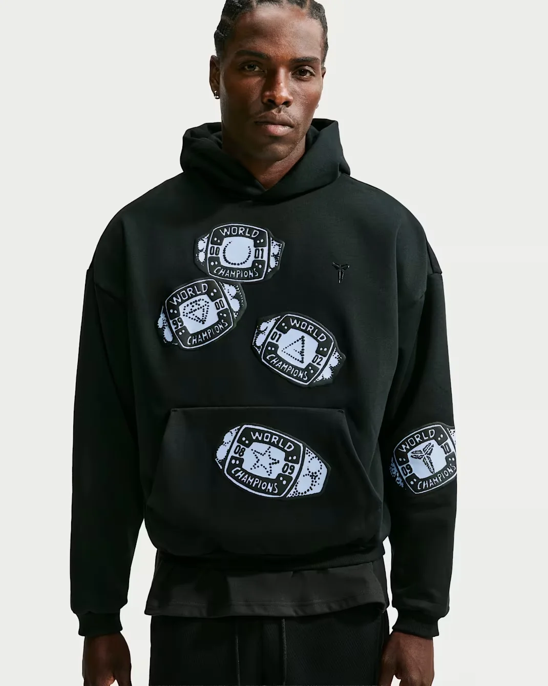 Black Nike Kobe hoodie with white World Champions ring graphics across the front and sleeve.