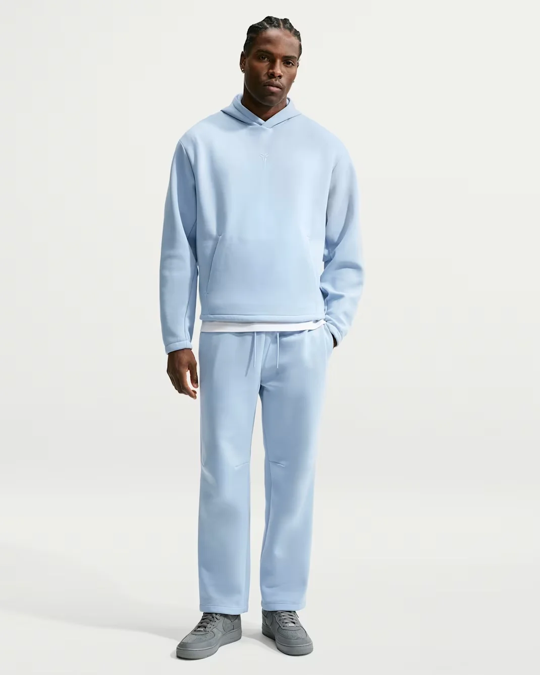 Model wearing a light blue Nike Kobe Therma-FIT hoodie and matching pants.