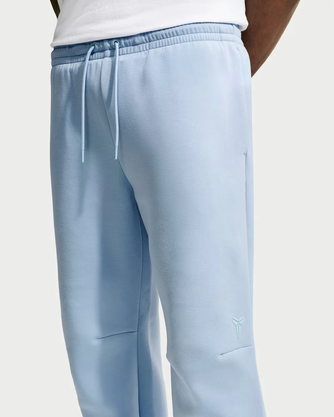 Light blue Nike Kobe Therma-FIT pants with drawstring waist and Kobe logo.