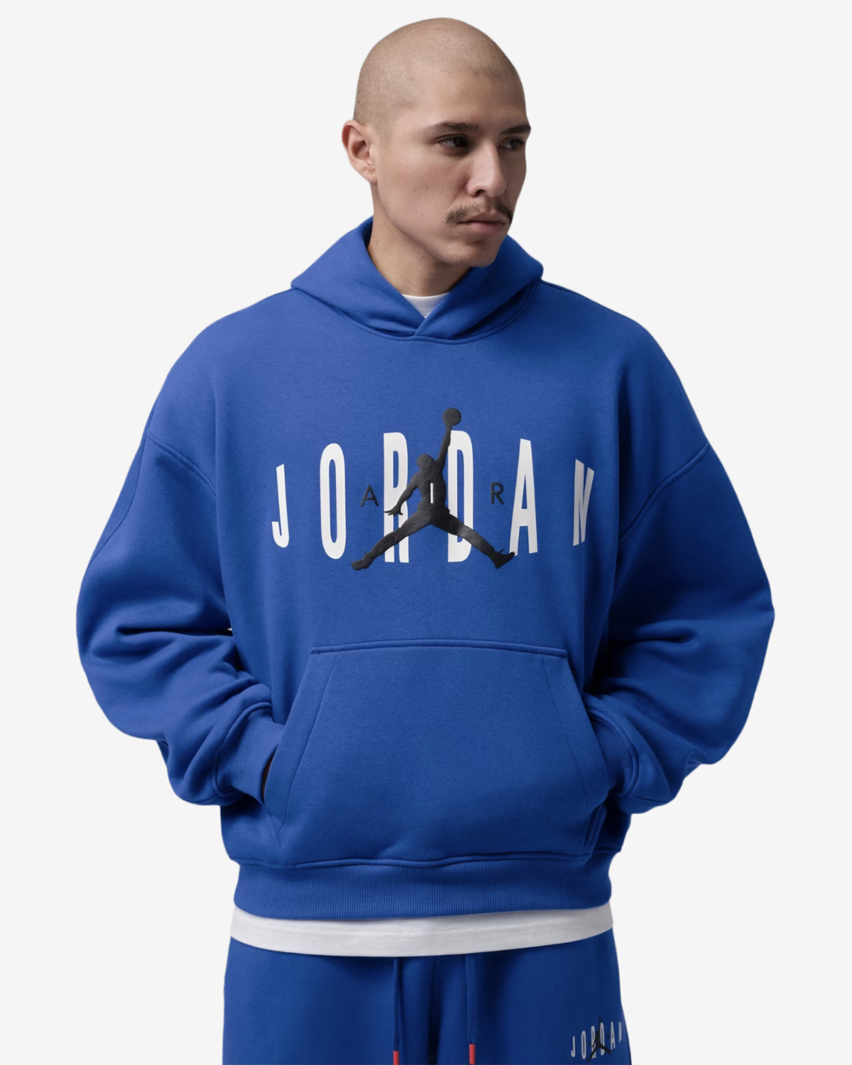 Jordan Brooklyn Graphic Oversized Pullover Hoodie in royal blue featuring white Jordan lettering, a black Jumpman logo, and a front kangaroo pocket.