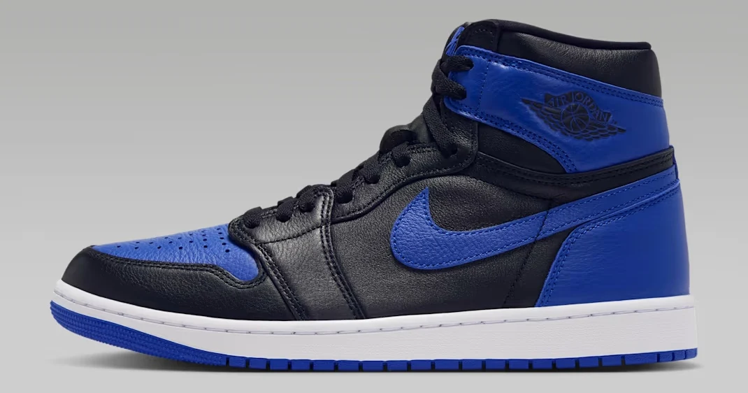 Air Jordan 1 High OG Royal sneakers featuring black leather, royal blue overlays, matching blue Nike Swoosh and white midsole, shown from the side.