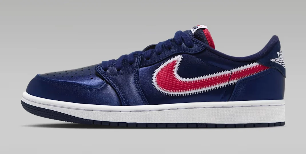 Air Jordan 1 Low OG Howard sneaker featuring a navy blue upper, red embroidered Nike Swoosh with white stitching, and white midsole, shown from the side.