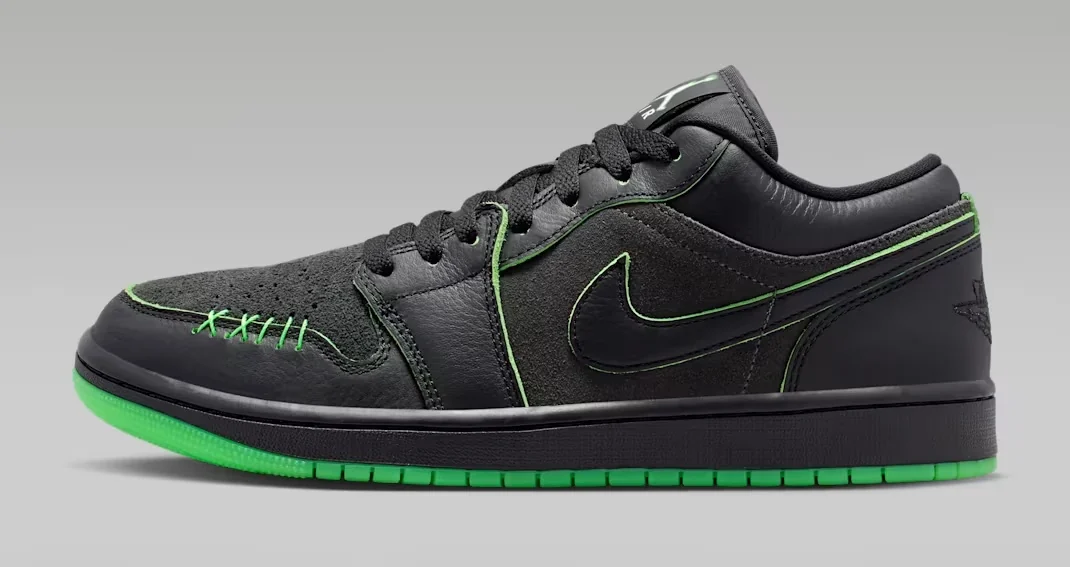 Air Jordan 1 Low SE Halloween sneaker featuring a black leather and suede upper, bright green stitching, black Nike Swoosh and green outsole, shown from the side.