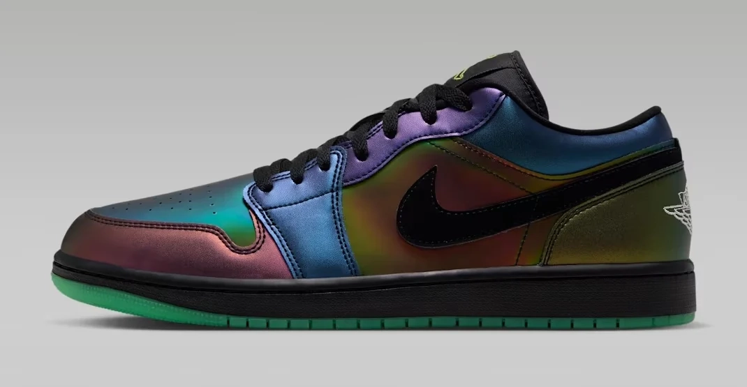 Air Jordan 1 Low SE Magic Ball Space Jam sneaker featuring an iridescent multicolor upper, black Nike Swoosh, black laces and green outsole, shown from the side.