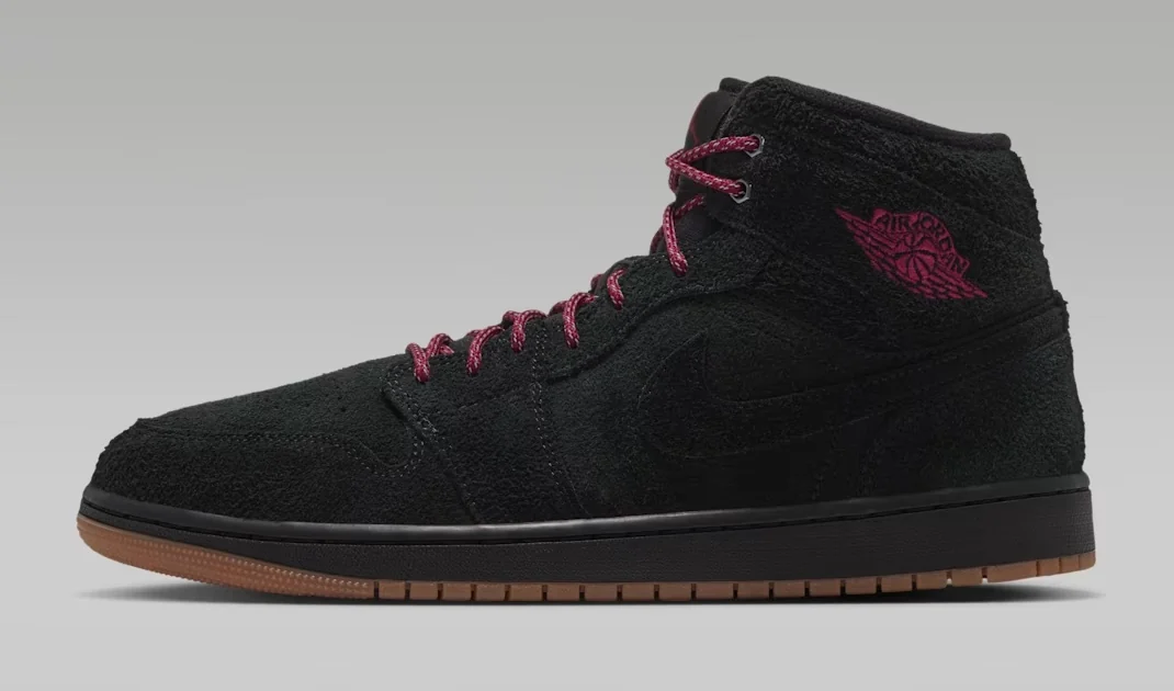 Air Jordan 1 Mid SE Black Team Red sneaker featuring a black suede upper, Team Red laces and Wings logo, black Nike Swoosh and gum rubber outsole, shown from the side.