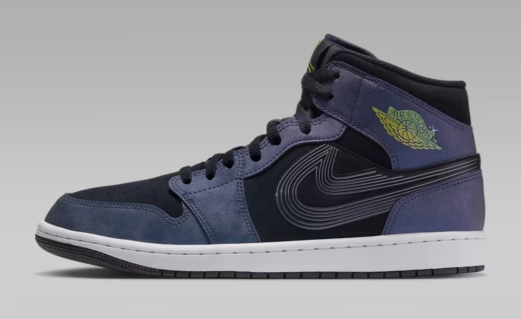 Air Jordan 1 Mid SE Space Jam sneaker featuring a black upper, purple-blue suede overlays, oversized black Nike Swoosh and green Wings logo, shown from the side.
