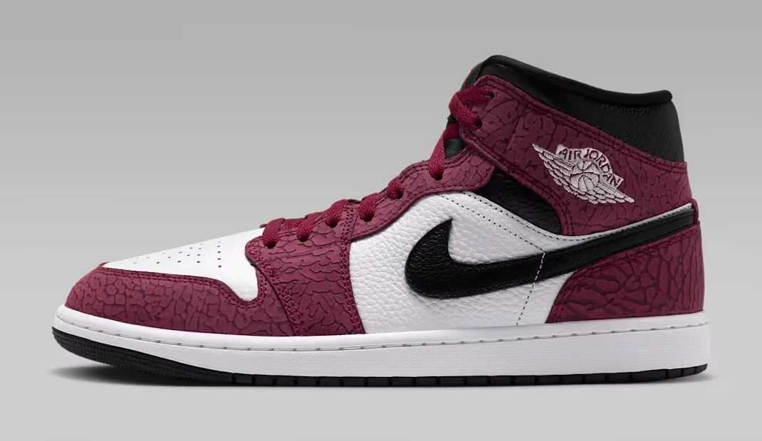 Air Jordan 1 Mid SE Team Red Elephant Print sneaker featuring textured burgundy overlays, white leather panels, a black Nike Swoosh and white midsole, shown from the side.